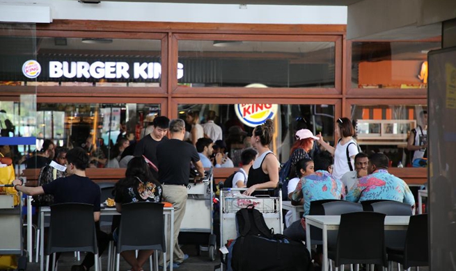 Tourists take rest at airport during state of emergency in Male, Maldives